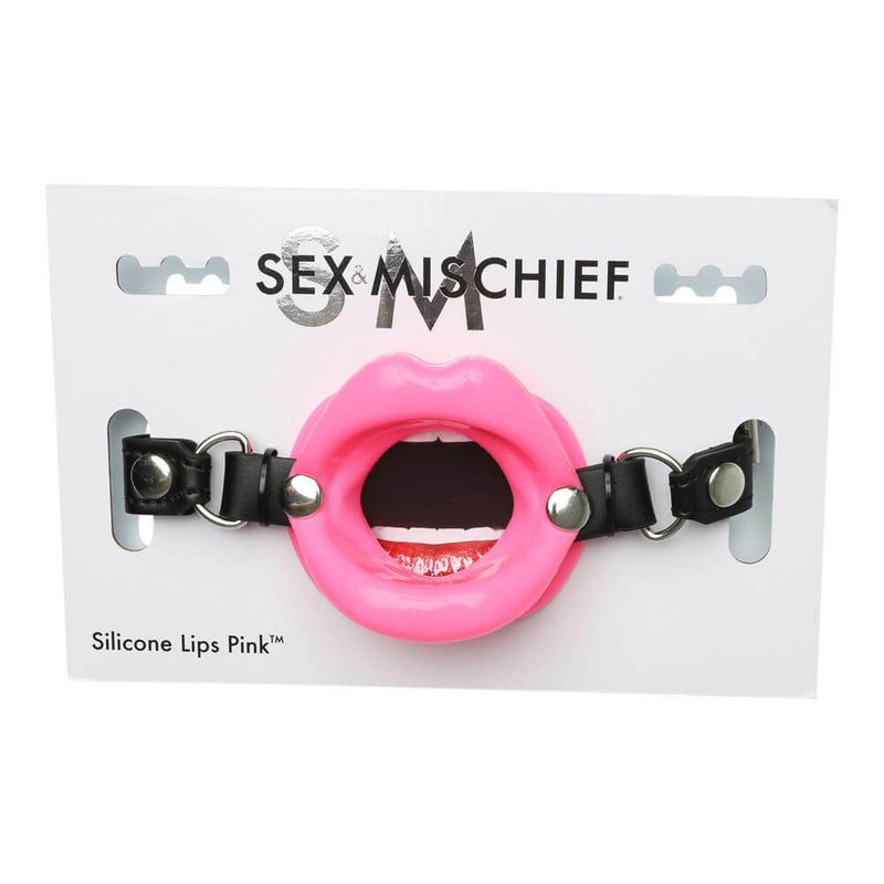 The Sportsheets Silicone Lips Mouth Gag in its packaging. The white board it's attached to has a mouth design on it, and the Sportsheets Silicone Lips Mouth Gag rests on top of the mouth design when in the packaging. This packaging doesn't provide any protection for storage. | Kinkly Shop