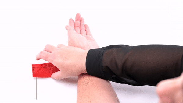 GIF shows a person handling one of the cuffs from the kit. The person wraps it around their wrist and fastens it with the Velcro strap. They then pull the tether tight to show the durability of the cuffs. The text says "Perfect for role play". | Kinkly Shop