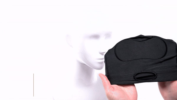 A GIF of a person putting a Sportsheets Shadow Hood on top of a face mannequin to show how it goes on. | Kinkly Shop