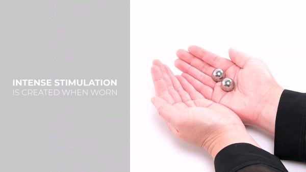 GIF showing a person's hands handling the Sportsheets Stainless Steel Ben Wa balls. They pass them from hand to hand to to show their size and how they move. The written text says "Intense stimulation is created when worn". | Kinkly Shop