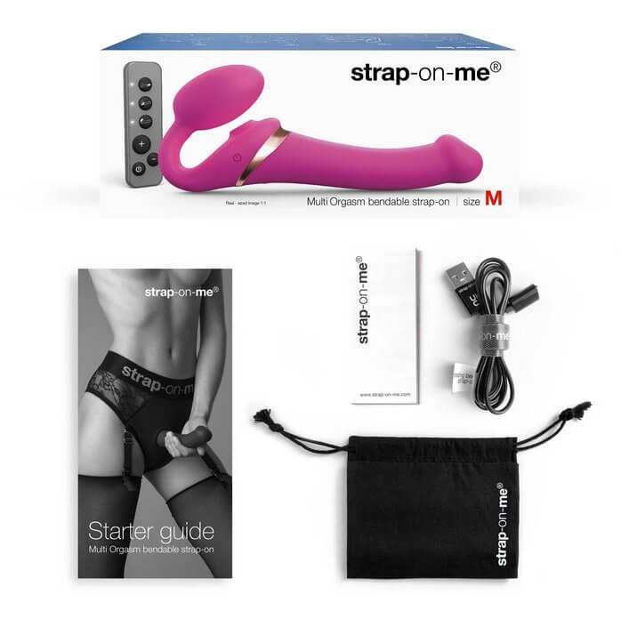 The Strap-on-Me Vibrating Licking Strapless Strap-on and everything it comes with. There's the starter guide, the vibrator itself, a storage bag, the remote, and the charging cable. | Kinkly Shop