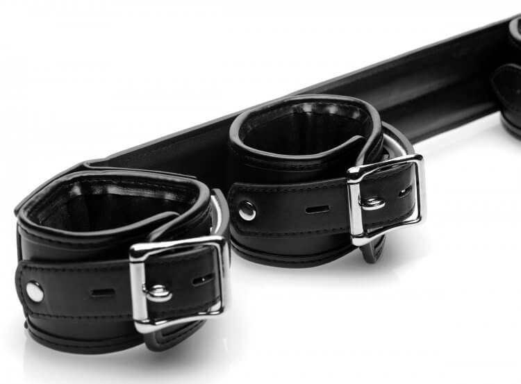 Close up of the cuffs of the STRICT Spreader Bar. The image shows the locking buckle that each one of the cuffs has. | Kinkly Shop