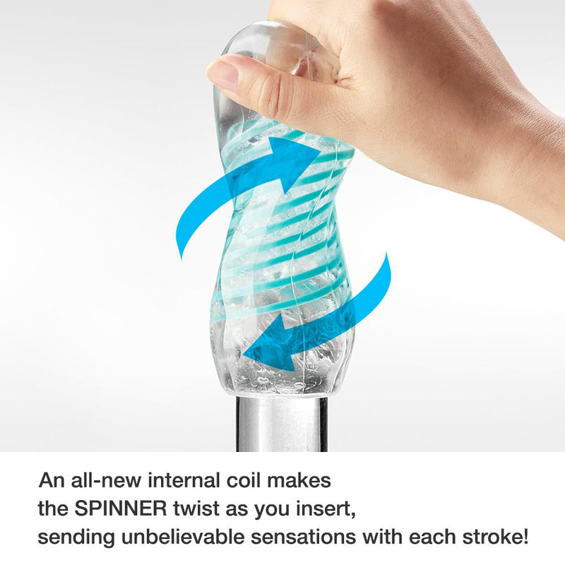 A hand grips the Tenga Spinner as it strokes it up and down on a glass dildo. Two illustrated arrows show the twisting motion that the Tenga Spinner makes when stroked. The caption reads "An all-new internal coil makes the Spinner twist as you insert, sending unbelievable sensations with each stroke!" | Kinkly Shop