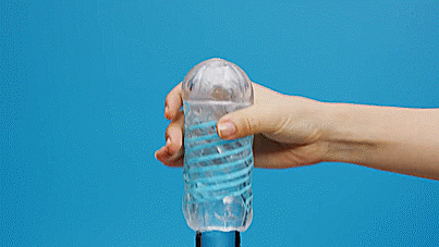 GIF of the Tenga Spinner being used on a glass dildo. It shows how the spiral design causes the stroker to "swirl" around the dildo as the hand moves the stroker up and down. The text on the GIF says "Spiral Motion". | Kinkly Shop