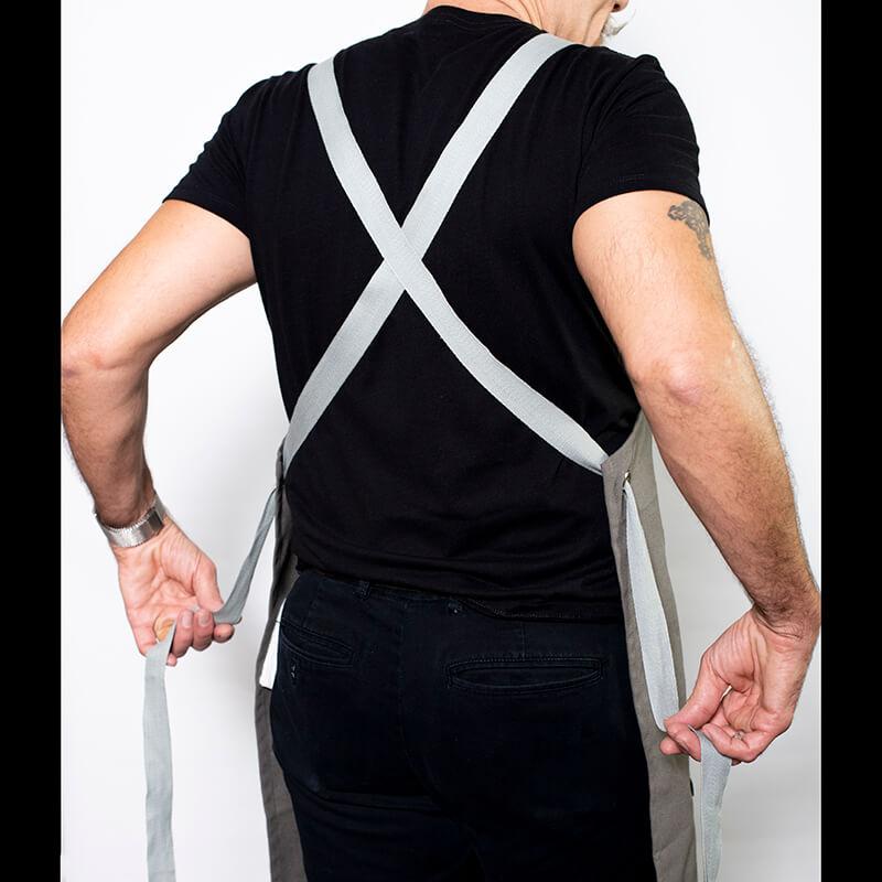 Picture showing the criss-cross apron straps on the back with the adjustable 60" apron straps of the I Rub My Own Meat Apron | Kinkly Shop