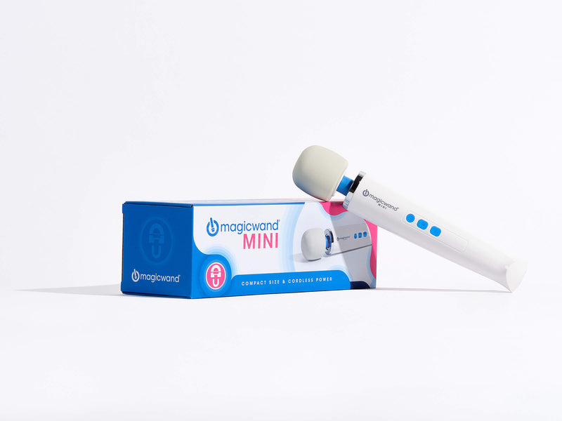 The Vibratex Magic Wand Mini Wand Massager leaning up against the cardboard box that it comes in. The box boasts "Compact Size and Cordless Power". | Kinkly Shop