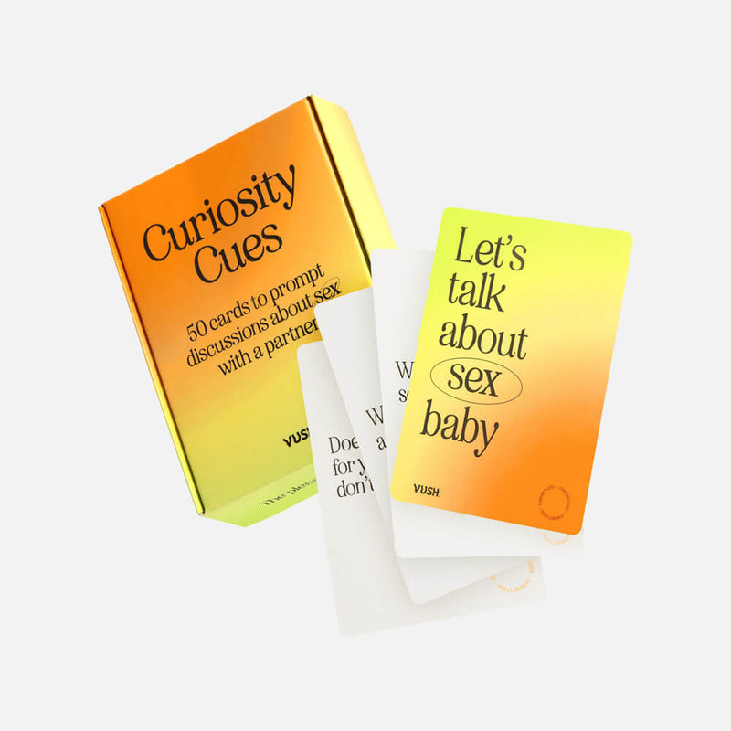 Box of the Curiosity Cues with a few of the cards open and spread out in front of the packaging. The box has an orange-to-yellow gradient. | Kinkly Shop