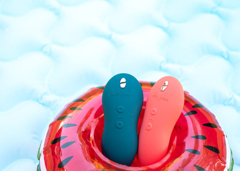 Both of the We-Vibe Touch X colors sitting together in a pool floatie against a light blue background that feels like a pool. | Kinkly Shop