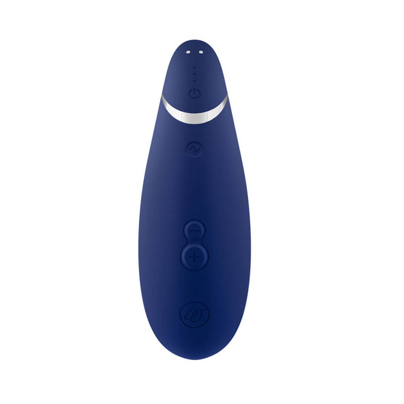 Buttons on the handle of the Womanizer Premium 2. The magnetic charging ports are at the very base of the handle where the toy charges. Above that, there are three LED lights that help communicate things about the vibrator. Above that, you'll find the power button. Above this, you'll find the pattern button which can be pressed to access additional features. Near the top of the handle, directly opposite of the suction tip on the opposing side, there's the Plus and Minus buttons. | Kinkly Shop