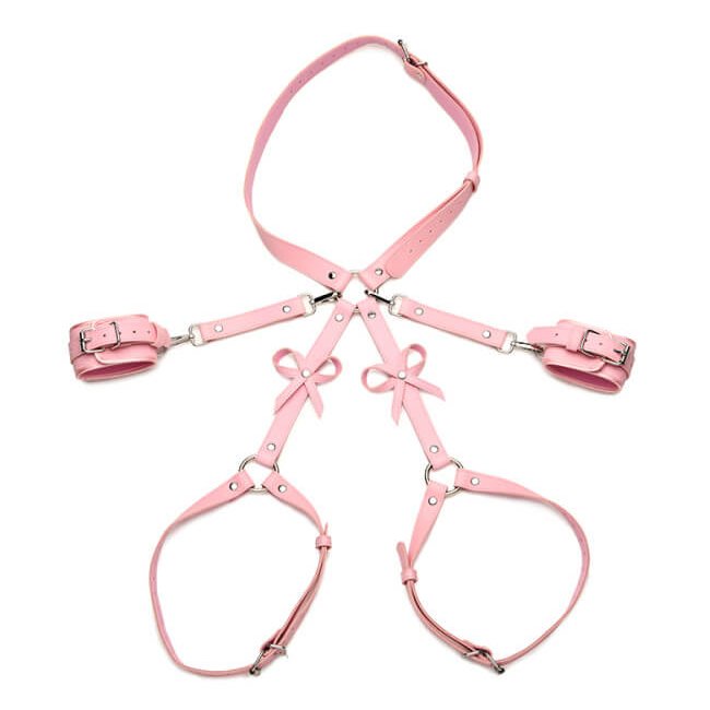 The Strict Bondage Harness with Bows in pink laid flat against a white background. The double layered straps on the hip harness and two thigh cuffs showcase how adjustable both of the wraps are. | Kinkly Shop